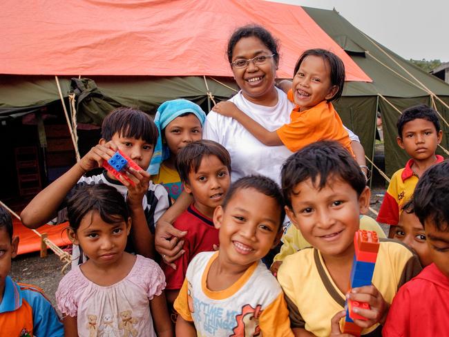 Grace Hokum, director of the Child Friendly Spaces, surrounded by children at the Gedung Sosial Center in Banda Aceh, Sumatra, Indonesia. Picture: World Vision