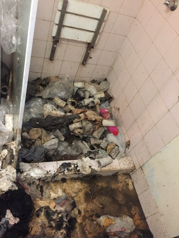 Rubbish including soiled toilet paper in what was once the home’s shower