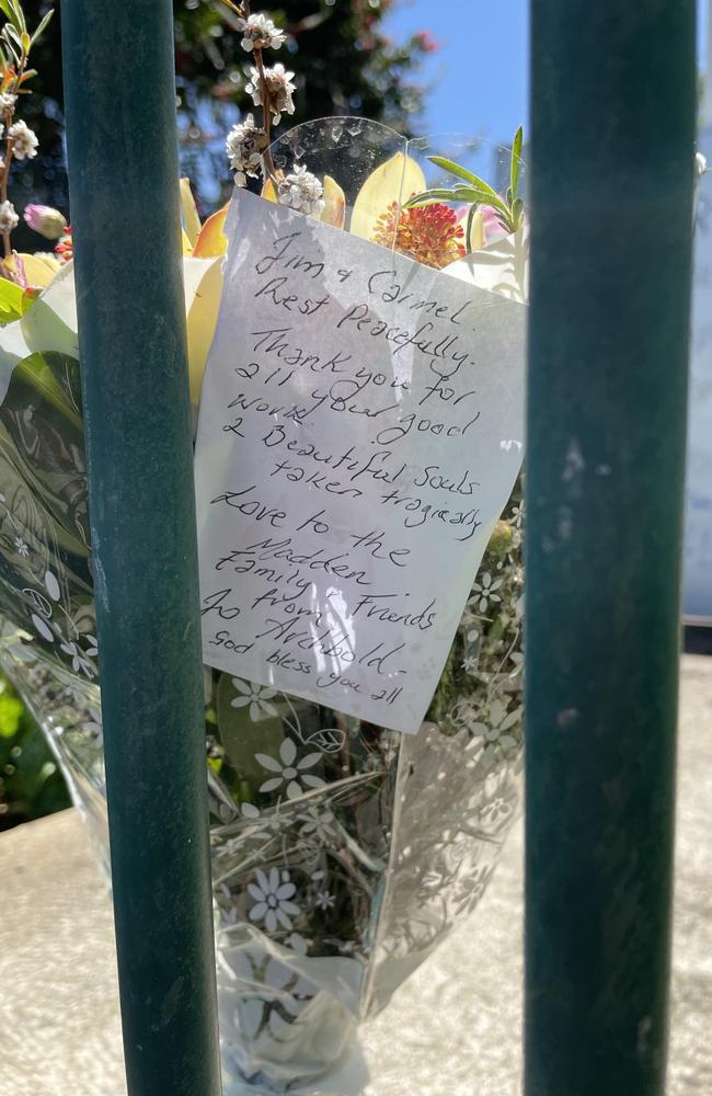 A bouquet of flowers is rested behind the closed front gate at the Koroit Lions Club Op Shop on Saturday.