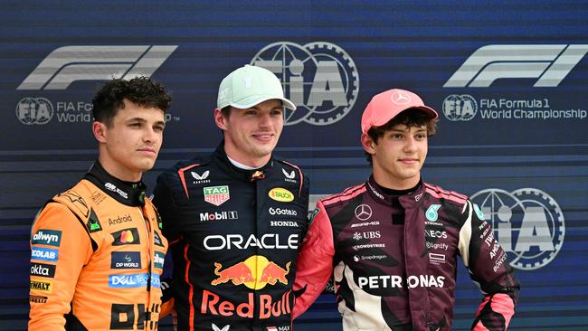 Max Verstappen (C), winner of the pole position, stands alongside Lando Norris (L) and Andrea Kimi Antonelli (R). Photo by Chandan Khanna / AFP)