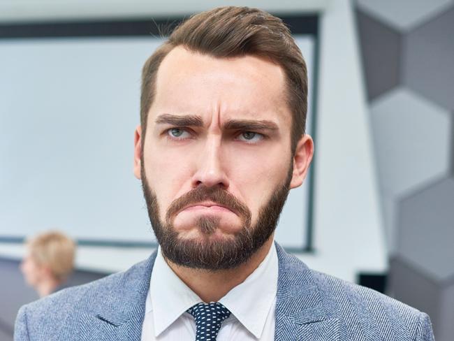 CAREERS: Portrait of sad bearded businessman holding box of personal belongings being fired from work in company, copy space.Unfair dismissal. Fired. iStock.