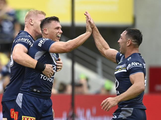 Scott Drinkwater celebrates with Reece Robson after the latter’s first try assist from a kick in the NRL. Picture: Ian Hitchcock/Getty Images