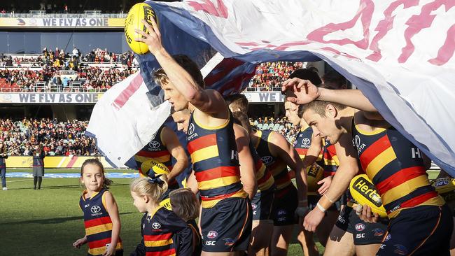 Sloane breaks through the supporter banner in the match against the West Coast Eagles.  Picture: Sarah Reed