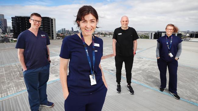 Prof Mark Putland, Dr Cara Moore, ICU consultant, Chris Mullins and Kellie Gumm at the Royal Melbourne Hospital helipad. Picture Rebecca Michael.