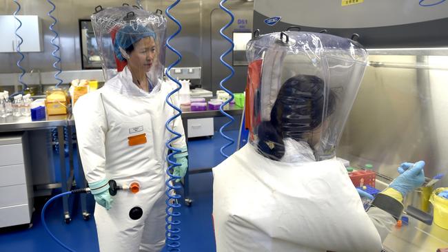 Virologist Shi Zheng-li, left, works with her colleague in the P4 lab of Wuhan Institute of Virology, in Wuhan in central China's Hubei province. As we learn more about what happened in China in late 2019, it ought to prompt a rethink, writes Gerard Baker. Picture: Getty