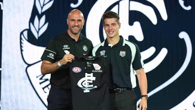 Liam Stocker is presented with his Carlton jumper by Chris Judd. Picture: AAP