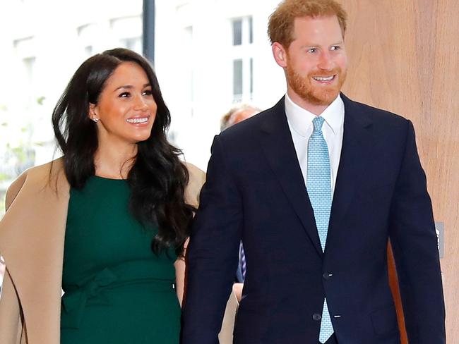 (FILES) In this file photo taken on October 15, 2019 Britain's Prince Harry (R), Duke of Sussex, and his wife Meghan, Duchess of Sussex react as they arrive to attend the annual WellChild Awards in London on October 15, 2019. - Meghan Markle has revealed she suffered a miscarriage in July this year, writing in the New York Times on November 25, 2020 of the deep grief and loss she endured with her husband Prince Harry. (Photo by Tolga AKMEN / AFP)