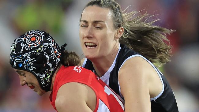 Aliesha Newman of the Swans is tackled by Saints player Clara Fitzpatrick in the round one match of the AFLW.