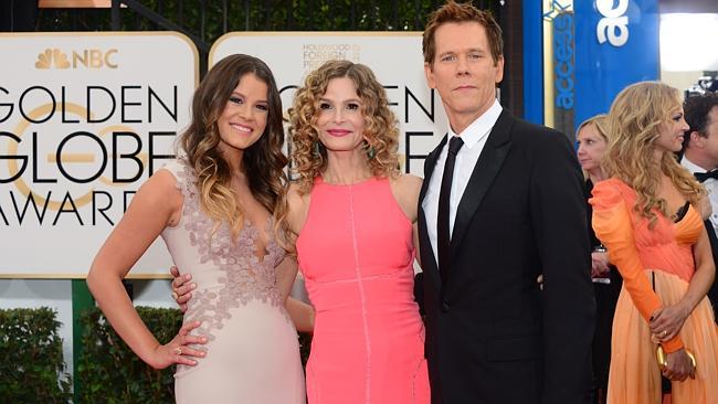 Miss Golden Globe Sosie Bacon, Kyra Sedgwick and Kevin Bacon strike a family pose on the red carpet.