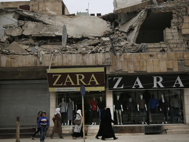 There are fears terrorists could rise again, modelling a new organisation on the bloodthirsty success of the Islamic State. Pictured are damaged buildings along a shopping strip in Syria. Picture: AP/Hussein Malla