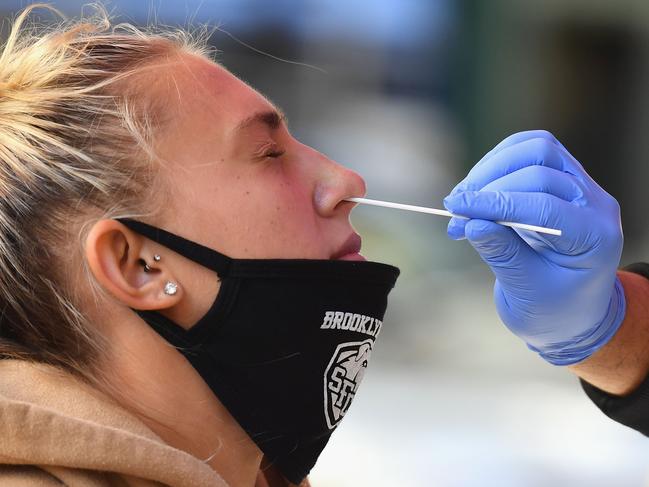 A medical worker takes a nasal swab sample from a student to test for COVID-19 at the Brooklyn Health Medical Alliance urgent care pop up testing site as infection rates spike on October 8, 2020 in New York City. - New York's governor announced earlier in the week tough new restrictions in several areas recording high infection rates to try to ward off a second coronavirus wave. (Photo by Angela Weiss / AFP)