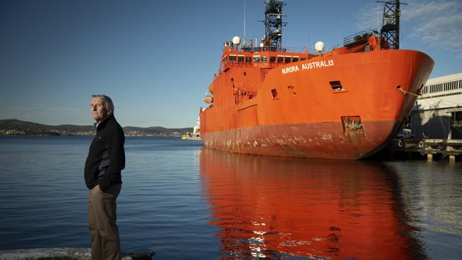 Michael Stoddart, former Chief Scientist at the Australian Antarctic Division with the Aurora Australis an icebreaker and research vessel in the back ground.