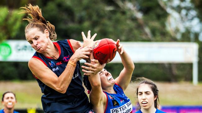 Norwood's Jo Hill in a fiercely contested mark with Central District's Abbie Sheer. Picture: Peter Argent