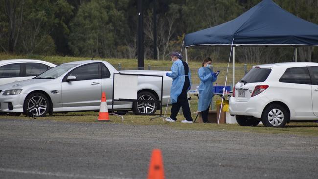 Ipswich locals queue for testing at the pop-up drive-through Covid testing site in the Raceview Hockey Grounds car park. 3 August, 2021. Photo: Ebony Graveur