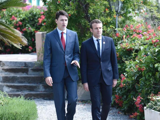 Canadian Prime Minister Justin Trudeau (R) and French President Emmanuel Macron talk as they attend the Summit of the Heads of State and of Government of the G7. Picture: AFP.