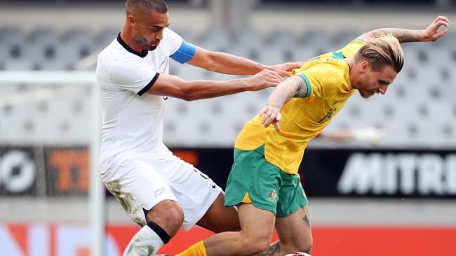 AUCKLAND, NEW ZEALAND - SEPTEMBER 25: Winston Reid, captain of New Zealand (L) tackles Jason Cummings of Australia during the International friendly match between the New Zealand All Whites and Australia Socceroos at Eden Park on September 25, 2022 in Auckland, New Zealand. (Photo by Fiona Goodall/Getty Images)