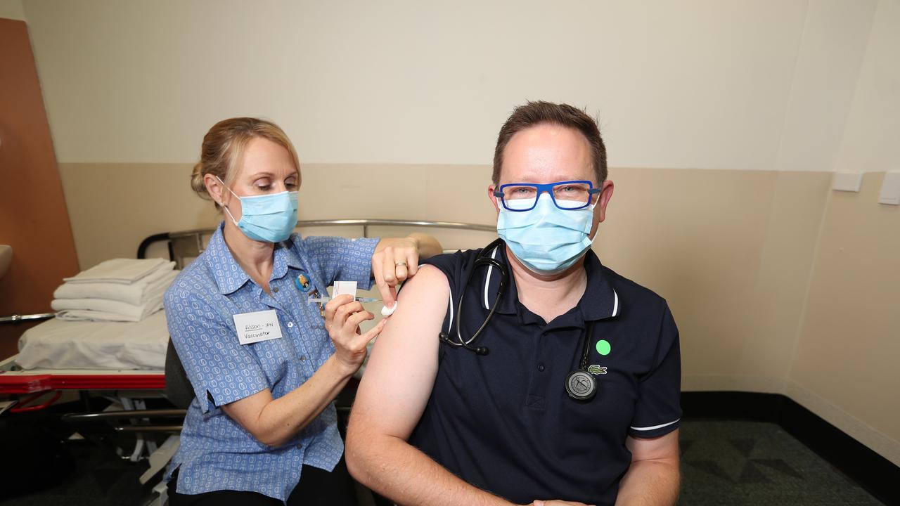 Nurse Alison Clancy a injects Associate Professor Paul Griffin, an infectious disease expert, with the AstraZeneca vaccine at the Mater Hospital. Pic Annette Dew