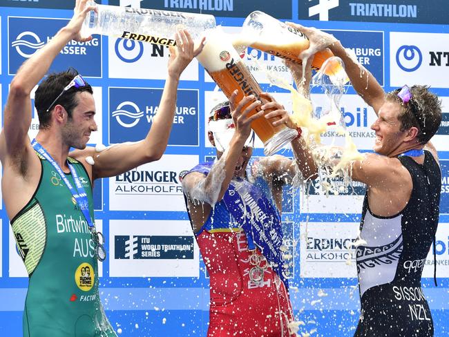 Jacob Birtwhistle, Mario Mola and Ryan Sissons celebrate the sprint distance race.