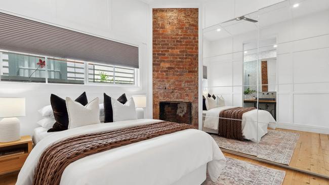 Timber wall panelling adds to the brick feature and baltic pine floorboards exposed during the renovation.