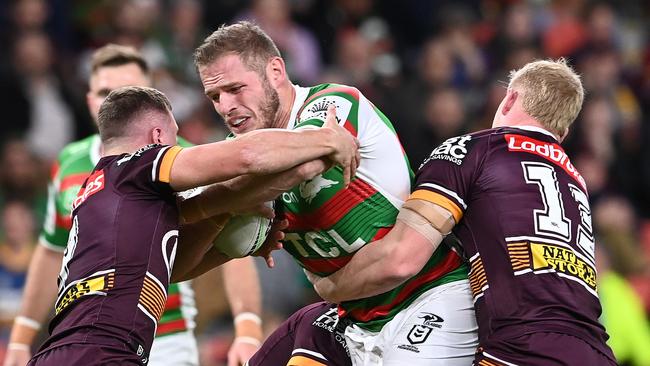 Tom Burgess tries to bust two Broncos tackles.