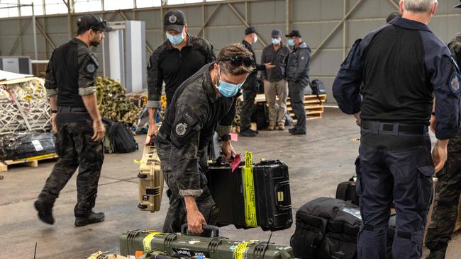 Australian Federal Police Special Operations members preparing their equipment prior to their departure from Canberra to the Solomon Islands.