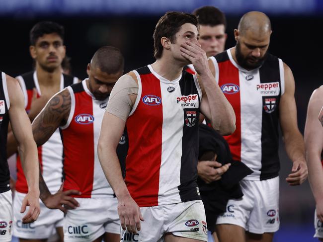 MELBOURNE, AUSTRALIA - JULY 15: Dejected St Kilda players walks from the ground after the round 18 AFL match between the Western Bulldogs and the St Kilda Saints at Marvel Stadium on July 15, 2022 in Melbourne, Australia. (Photo by Darrian Traynor/Getty Images)