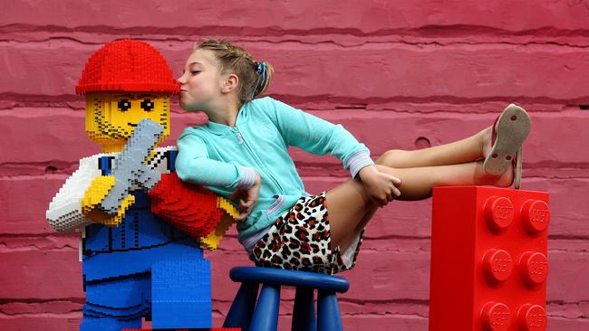 Mia Harris with Lego Man at Dreamworld. Photo: Adam Head