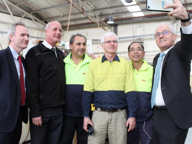 Prime Minister Malcolm Turnbull takes a selfie with staff and Banks MP David Coleman, left, and BP Interior’s Managing Director Oliver vom Bruch, second left, on Tuesday.