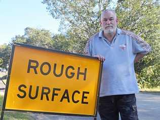 Chris Kirby is unhappy with the state of the road outside his Tweed Lane residence. Picture: Josh Preston