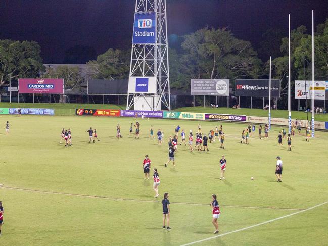 Kids fill the field at halftime of the NTFL mens game to kick balls around. Picture: Floss Adams.