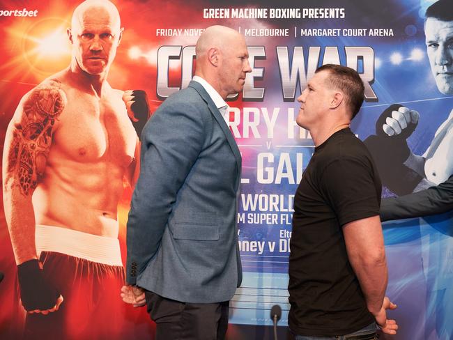 Former AFL player Barry Hall (left) and NRL Cronulla-Sutherland Sharks player Paul Gallen face off ahead of their Code War boxing launch in Melbourne. (AAP Image/Stefan Postles)