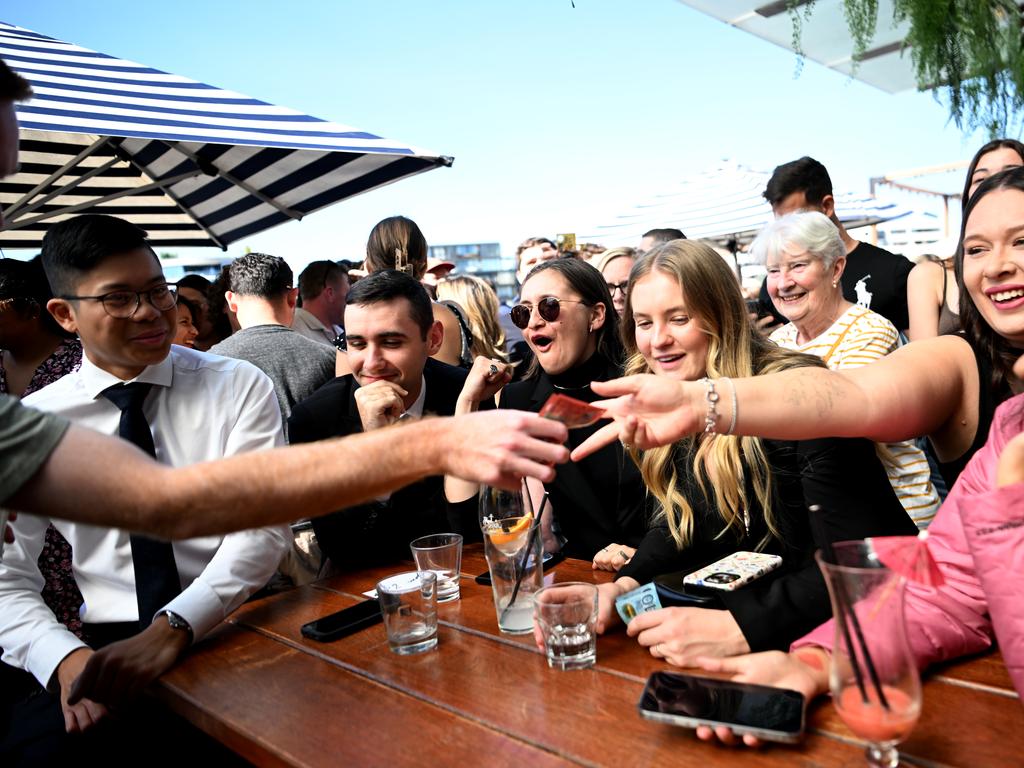 One woman in sunglasses can be seen cheering during one game (Photo by Tracey Nearmy/Getty Images)