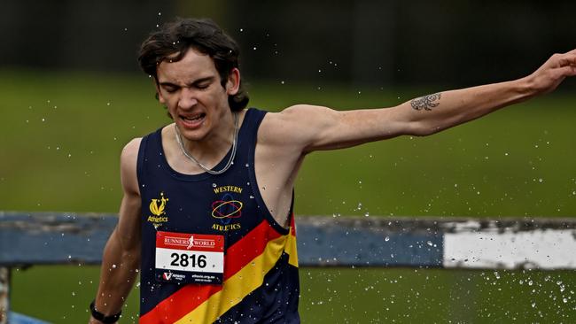 Liam Morgan hits the water during the steeplechase. Picture: Andy Brownbill