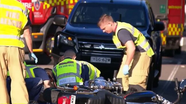 Paramedics treat Ian Schubert at the crash site. Picture: 9 News