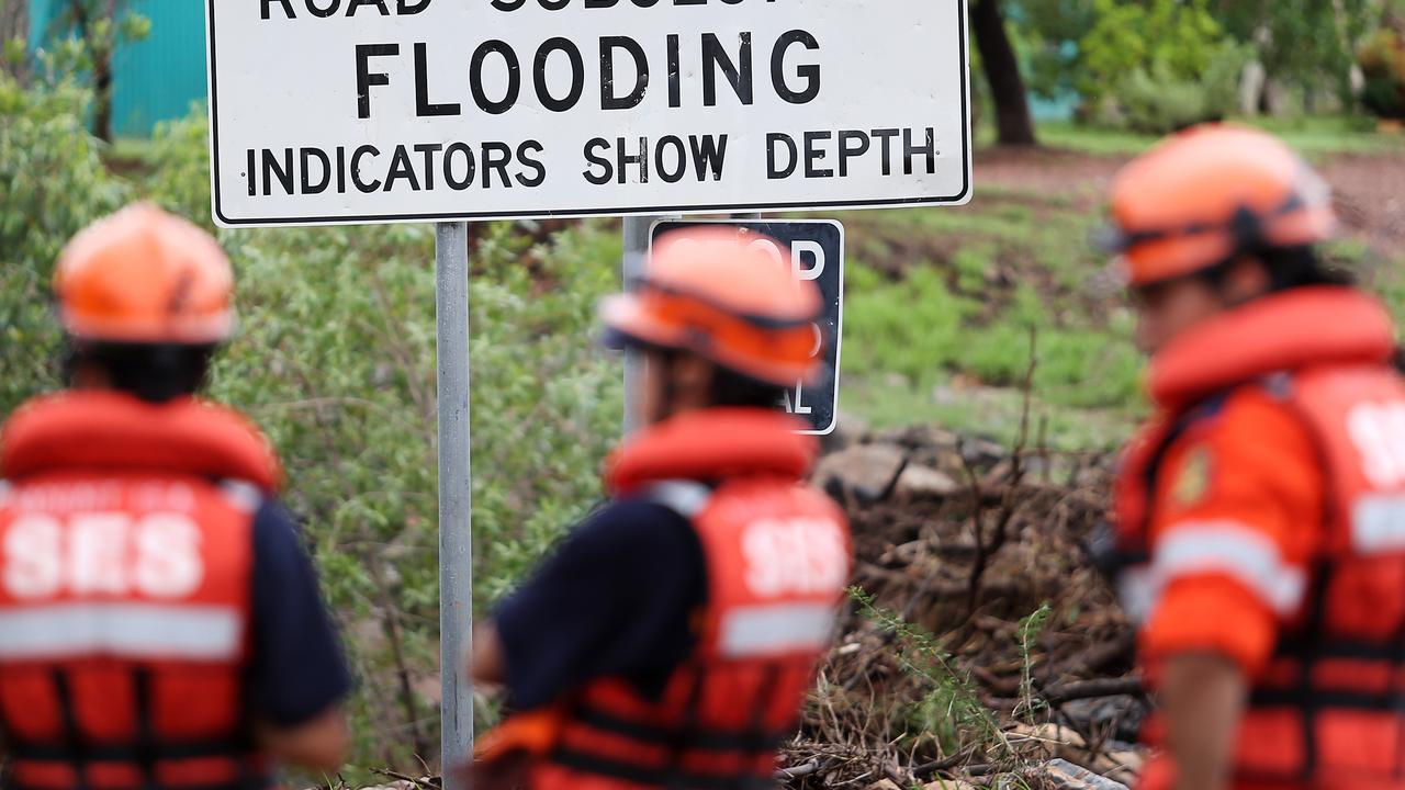 CMNEWS_Mt Isa SES and QFRS Crew photographed here about to retrieve the body of an unknown local male after he was washed away during flash flooding yesterday near the Leichhardt river Wednesday Jan.7th, 2014. Pictures: Jack Tran / The Courier Mail