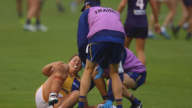 Parris Laurie is assisted by trainers after injuring a knee. Picture: Getty Images