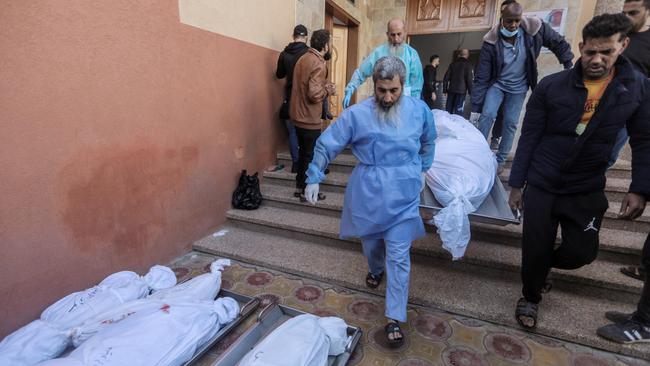 People mourn as they collect the bodies of Palestinians killed in an air strike on November 21, 2023 in Khan Yunis, Gaza. Picture: Ahmad Hasaballah/Getty Images