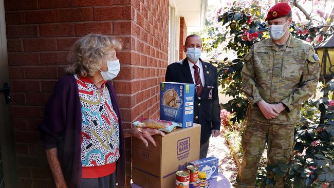 War widow Mavis Melville with former veteran 6RAR John O'Brien from Blacktown RSL Sub-Branch, and Private Steven Greening. Picture: Tim Hunter.