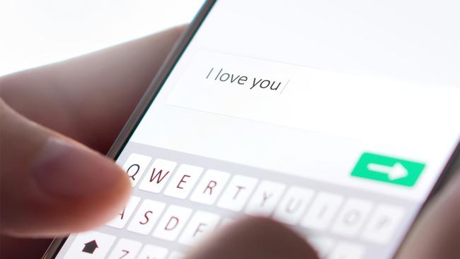 Sending I love you text message with mobile phone. Online dating, texting or catfishing concept. Romance fraud, scam or deceit with smartphone. Man writing comment. Fake profile. Internet safety. Picture: iStock.