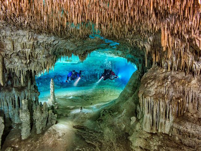 Underwater Photographer of the Year 2018. HIGHLY COMMENDED Category 1. Wide Angle Credit name: Herbert Meyrl/UPY 2018 Nationality: Germany. Location: Cenote Nariz, Yucatan, Mexico. “Cenote Nariz is the entrance to a large cave system in Yucatan. When I saw this perfect window opening into a large room ahead of us I signaled my team to stop. After mind mapping the spot I swam very cautiously through the window and placed 2 strobes in slave mode on either side behind the opening. Then I signaled my buddies to swim through the opening.”
