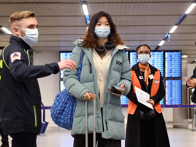 Passengers of a flight from China wait in a line for checking their COVID-19 vaccination documents as a preventive measure against the Covid-19 coronavirus, after arriving at the Paris-Charles-de-Gaulle airport in Roissy, outside Paris, on January 1, 2023. - France and Britain on December 30 joined a growing list of nations imposing Covid tests on travelers from China, after Beijing dropped foreign travel curbs despite surging cases -- and amid questions about its data reporting. (Photo by JULIEN DE ROSA / AFP)