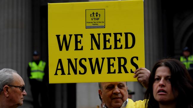 Taxi drivers protest on the steps of Parliament House, Melbourne. Picture: Tracey Nearmy/AAP.