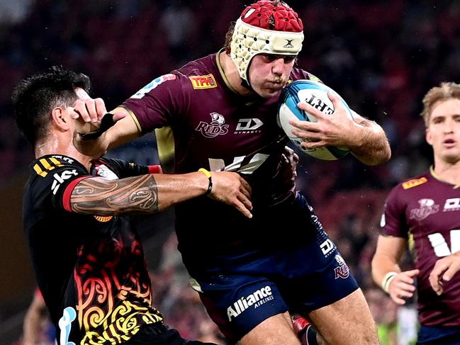 BRISBANE, AUSTRALIA - APRIL 29: Fraser McReight of the Reds is tackled during the round 11 Super Rugby Pacific match between the Queensland Reds and the Chiefs at Suncorp Stadium on April 29, 2022 in Brisbane, Australia. (Photo by Bradley Kanaris/Getty Images)