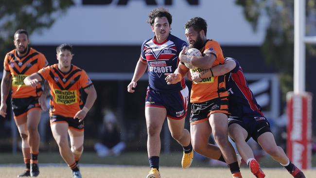 Piki Te Ora Rogers of the Southport Tigers under pressure against Runaway Bay Seagulls during the Rugby League Gold Coast minor semi final played at Owen Park, Southport, Gold Coast, Sunday, August, 28, 2022. Photo: Regi Varghese