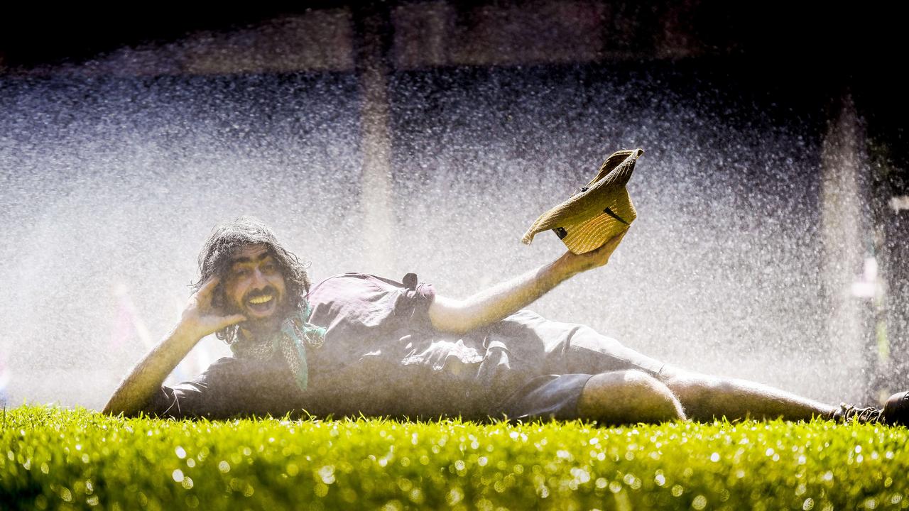 Yakka Fella is cooling off under the grass sprinklers at Rundle Park. Picture: NCA NewsWire / Roy VanDerVegt