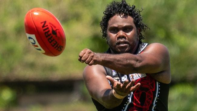 A rare sight this season. Former AFL Demon Austin Wonaeamirri firing out a handball for the Tiwi Bombers. Picture: Aaron Black AFLNT