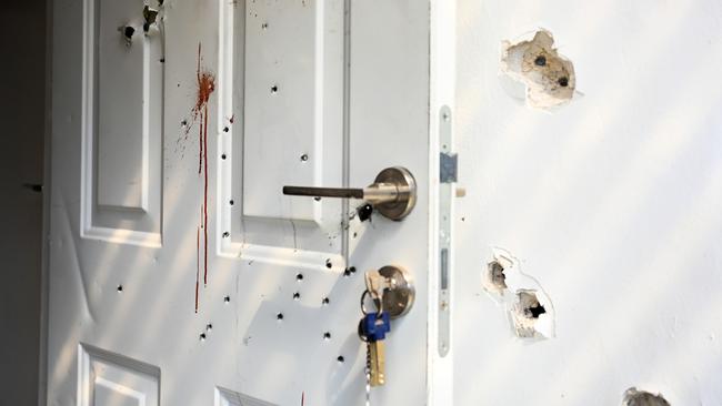 Gunshots and blood stains are seen on a door and walls of a house where civilians were killed days earlier in an attack by Hamas militants on this kibbutz near the border with Gaza, in Kfar Aza, Israel.