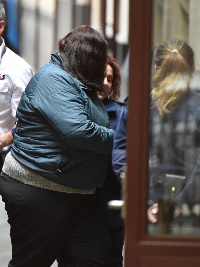 Katia Pyliotis being led into court for one of her four trials before she was freed.