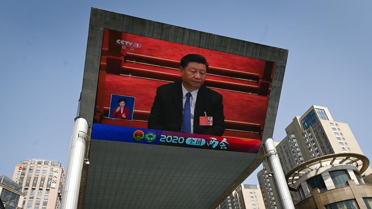 An outdoor screen shows live coverage of China’s President Xi Jinping attending the closing session of the National People’s Congress in Beijing on Thursday. Picture: Wang Zhao/AFP