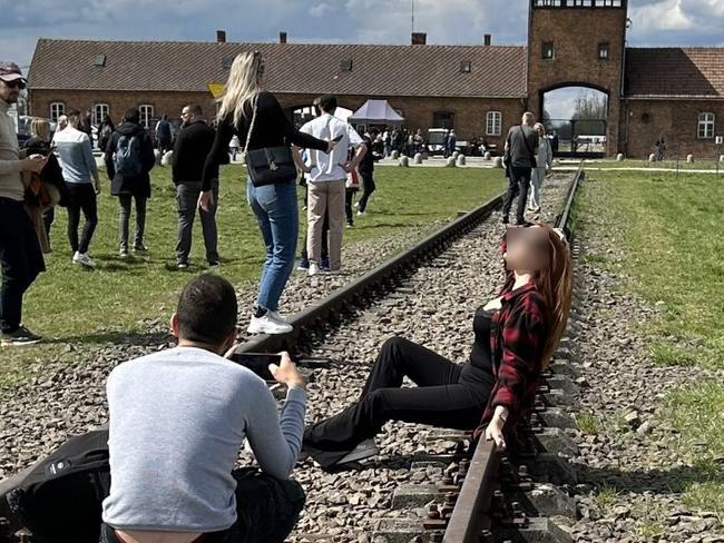 A photo of a woman posing at Auschwitz has gone viral. Picture: Twitter/Maria Murphy